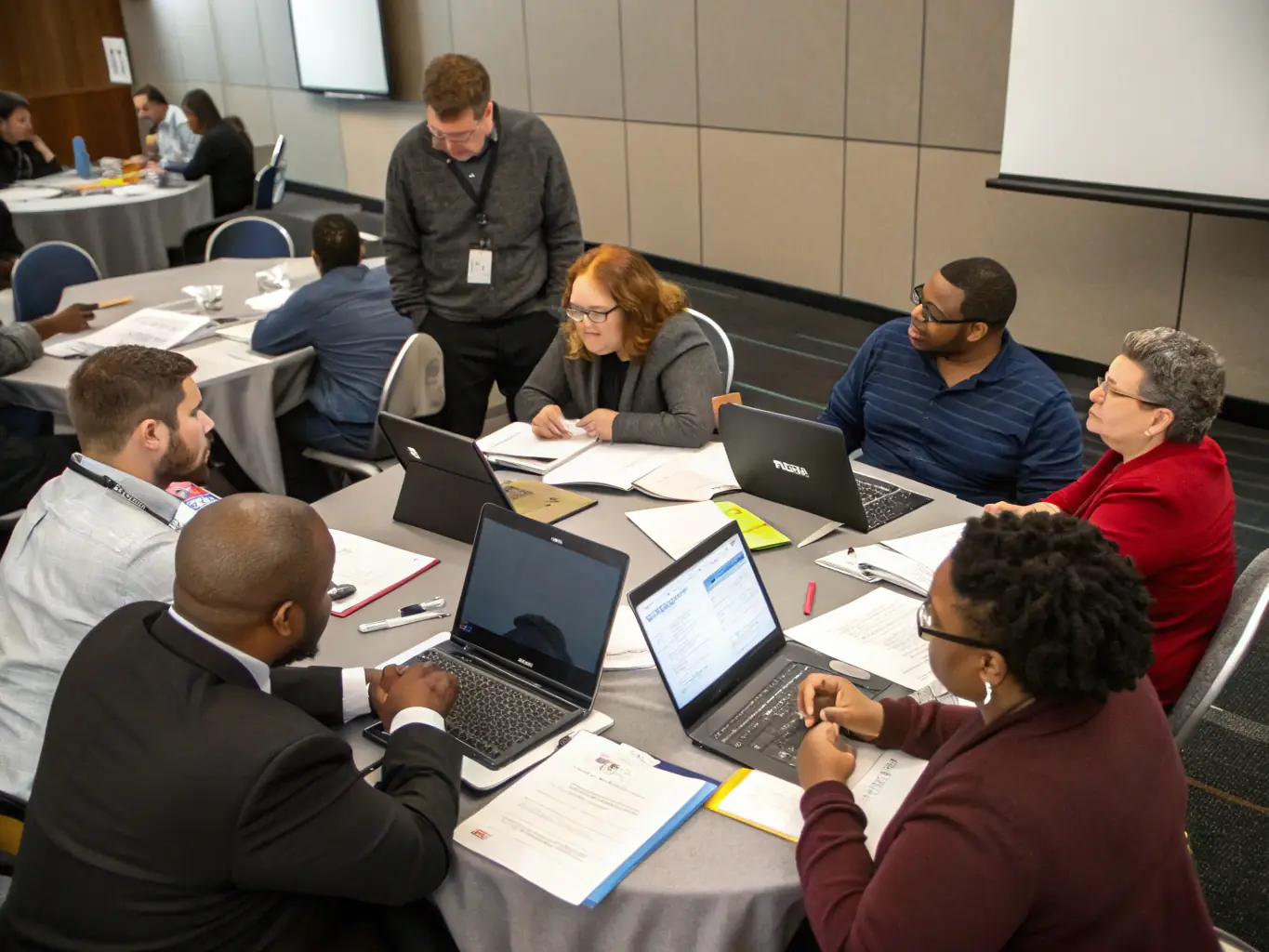 A group of individuals participating in an employment skills training workshop, learning and collaborating on job search strategies and interview techniques. The atmosphere is engaging and interactive.